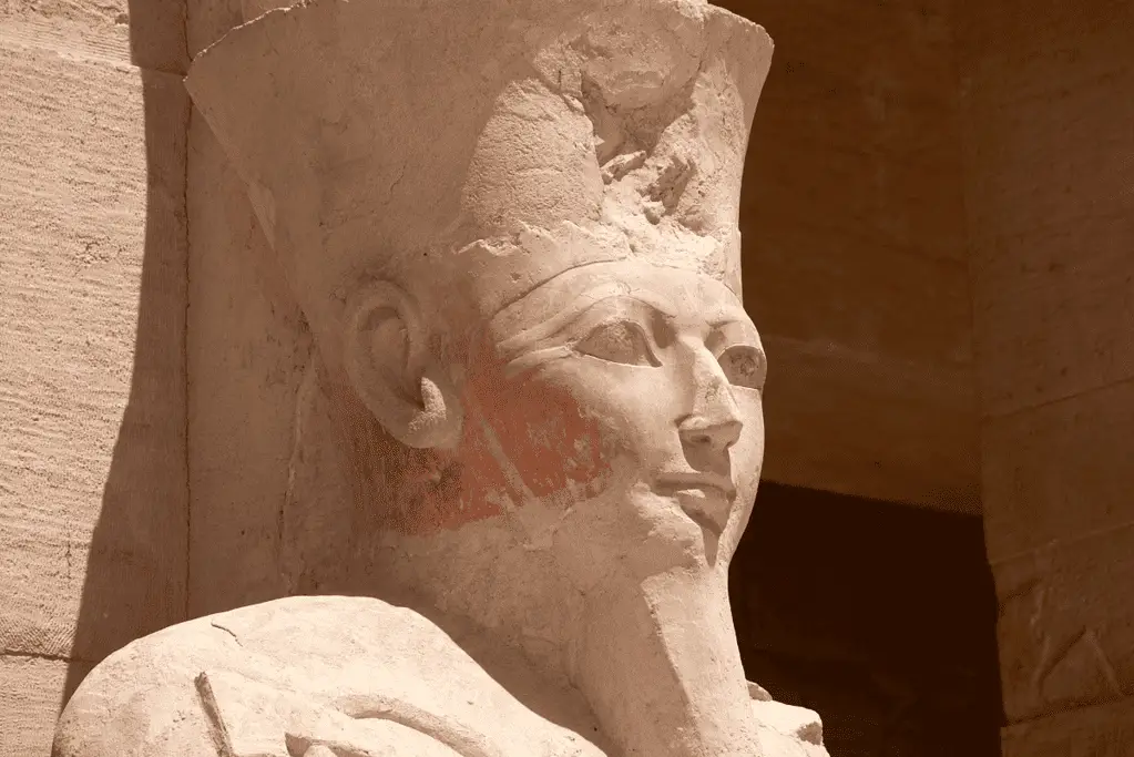 Image of a statue of Queen Hatshepsut located at Djeser-Djeseru, her mortuary temple, showcasing the powerful female pharaoh's regal visage.