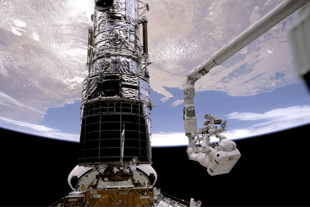 Image of the Hubble Space Telescope, a technological marvel named after the famous astronomer Edwin Hubble, positioned against the vastness of space.