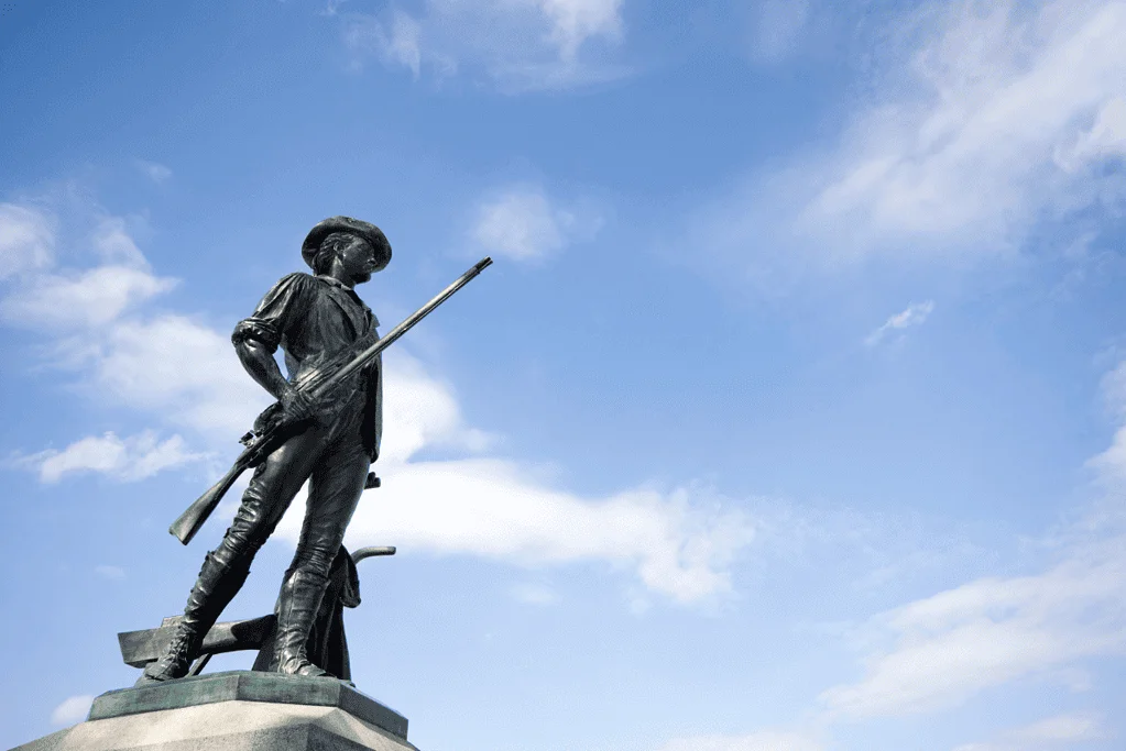Image of a bronze statue of a minuteman in Concord, Massachusetts, representing the brave souls who took part in the significant battles of the American Revolution.