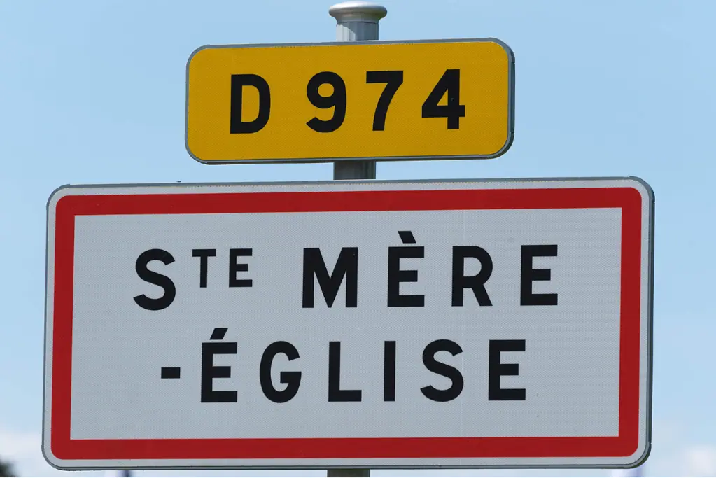 Image of a sign for the French town of St Mere Eglise for a blog post covering facts about D-Day.