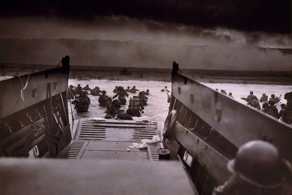 Image of American infantry disembarking from landing craft on June 5, 1944, Normandy France for a blog post covering interesting facts about D-Day.