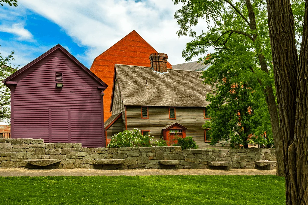 Image of a stone wall and memorial benches paying tribute to the accused Salem witches, a solemn reminder of a tragic chapter in American history.