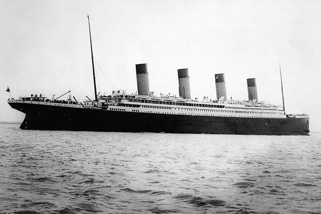 Image of a photograph of the RMS Titanic sailing gracefully on the sea, displaying its magnificence in the days prior to the unfortunate catastrophe.