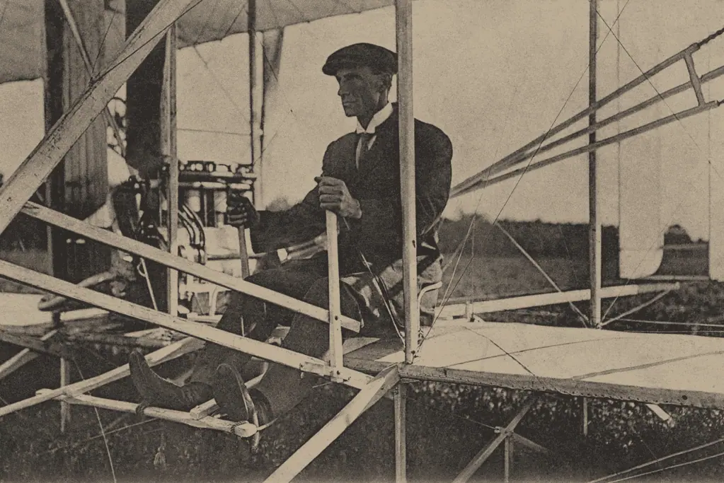 pioneers-of-aviation-wilbur-wright Image of Wilbur Wright at the controls of the glider his brother Orville and he built.