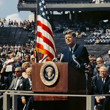 Image of JFK speaking at his inauguration in 1961 for a post providing a list of U.S. Presidents and party affiliated with.