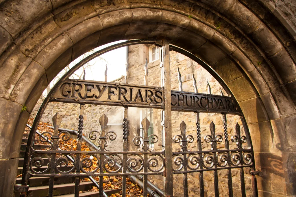 Image of an entry of the iconic Greyfriars Churchyard in Edinburgh, Scotland for a blog post covering the most famous cemeteries in the world.