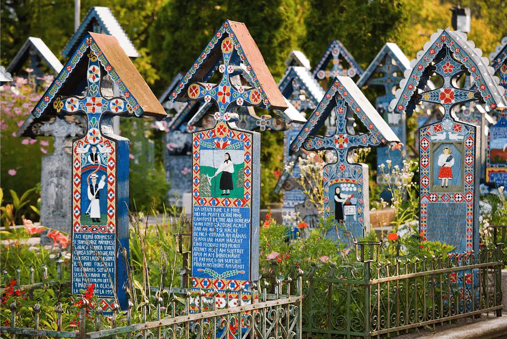 Image of Merry Cemetery: Where Romanian villagers paint death in Technicolor smiles.
