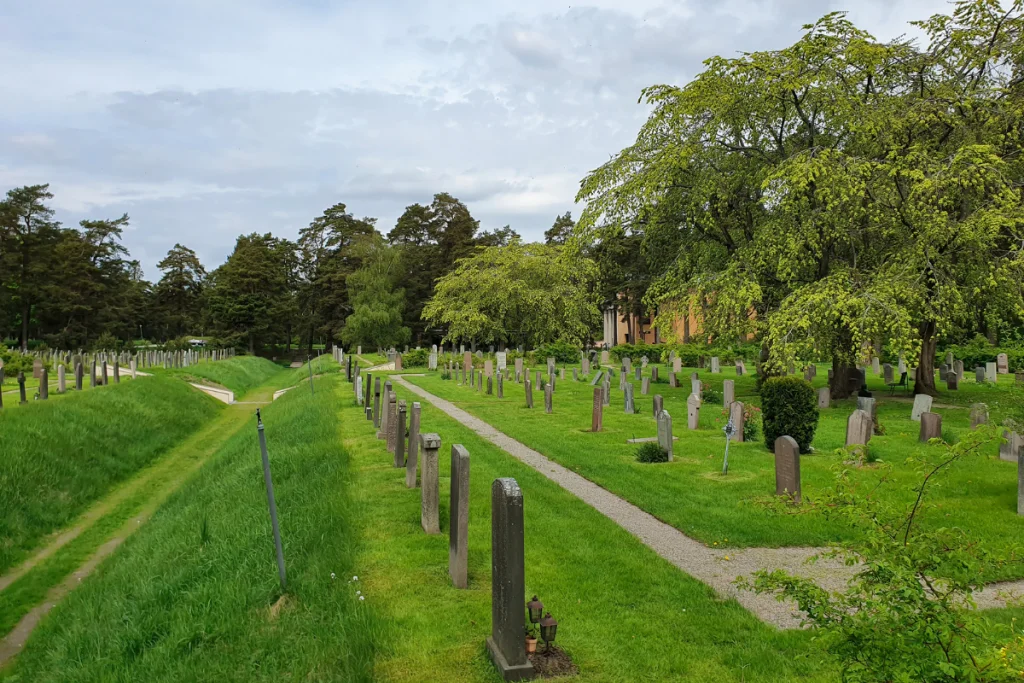 Image of Skogskyrkogården: Where Swedish design meets eternity in a modernist forest of remembrance for a blog post covering the most famous cemeteries in the world.