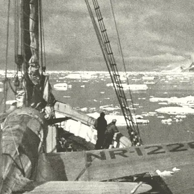 Image of a ship navigating ice floes in Antarctica for a blog post covering famous expeditions to antarctica.